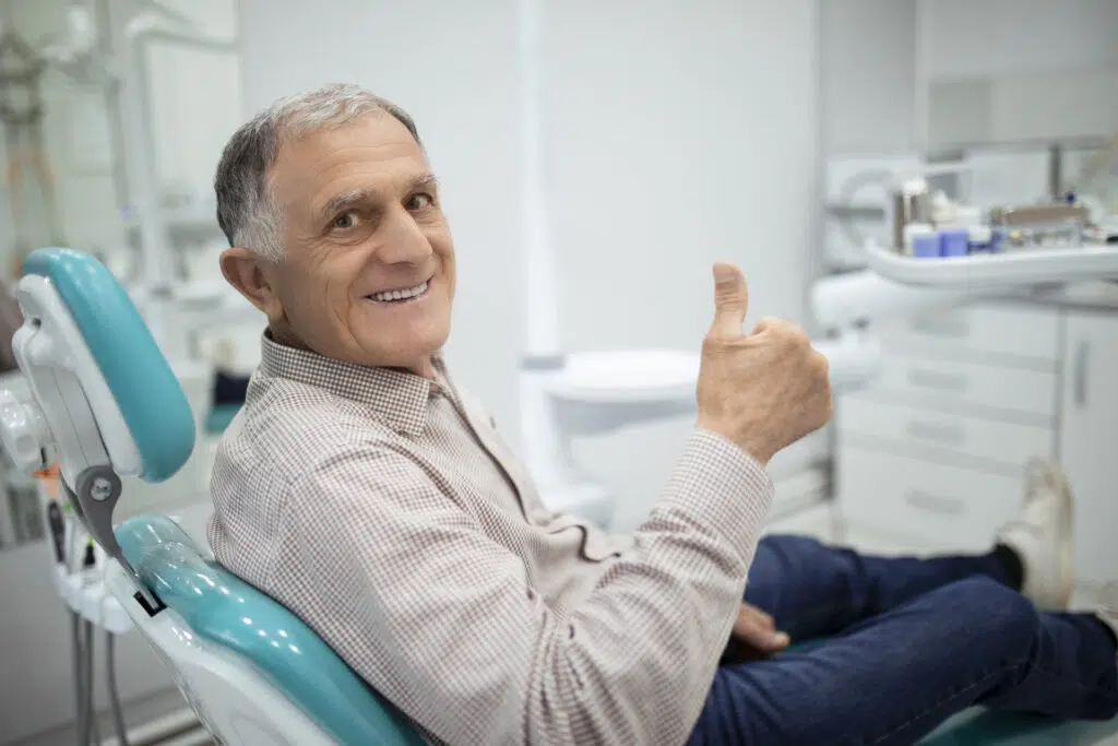 Old senior man sitting in a dental chair